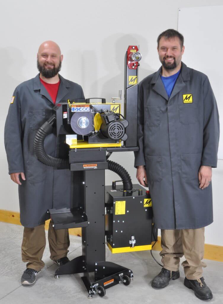Gerd Bauer, left and Erik Bauer, right are next to their Lawn Mower Blade Sharpener with its balancer and dust collector.