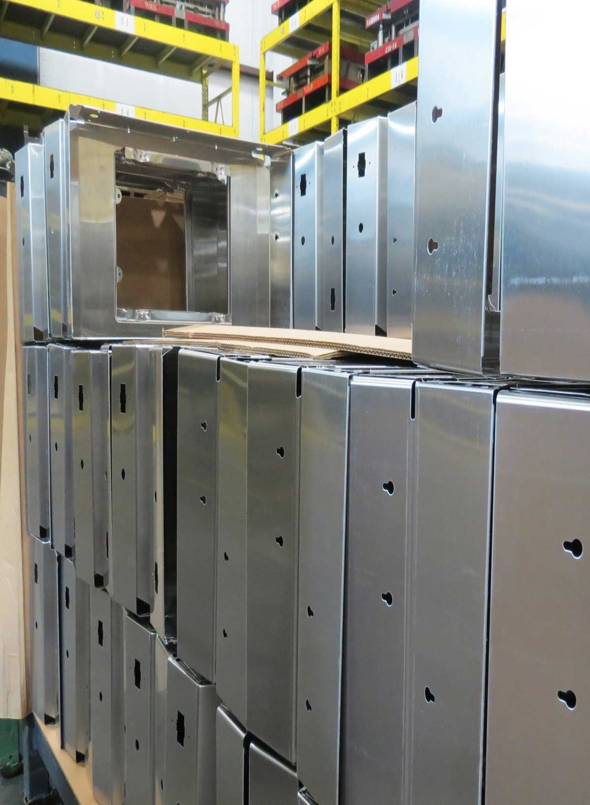 Stainless steel side tables, passing final inspections after metal stamping, ready for packaging and delivery.