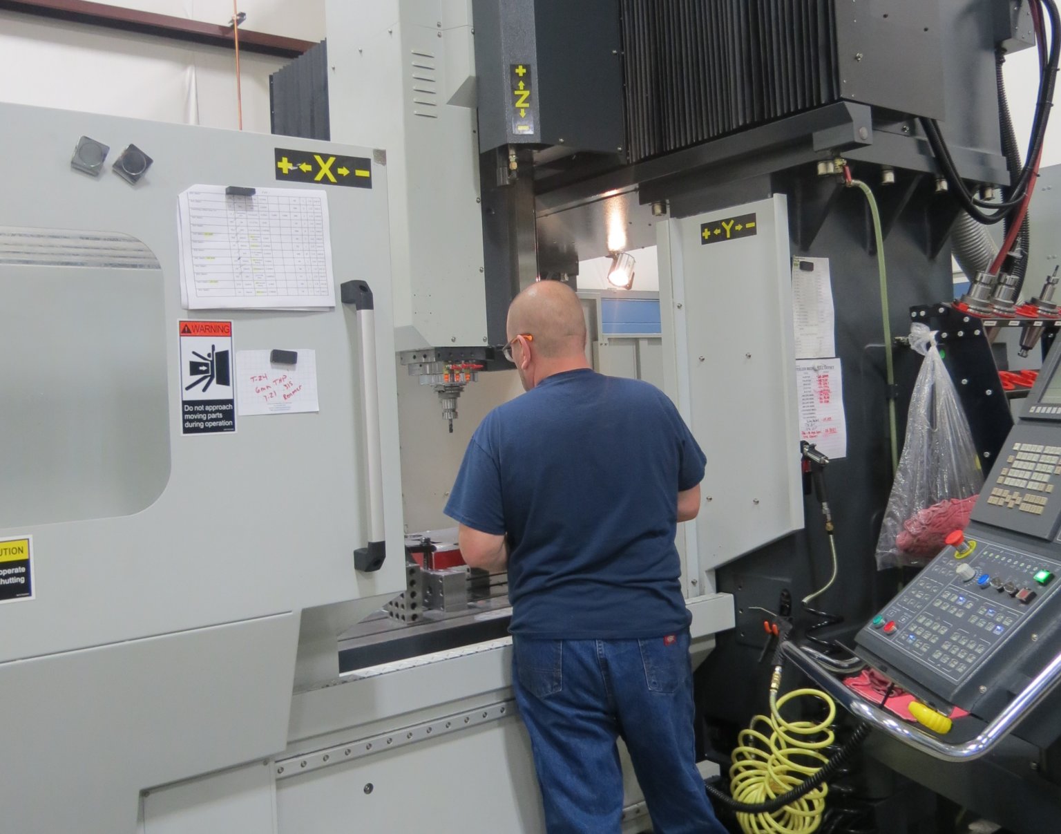 Man working to attain precision metal components for your production tooling